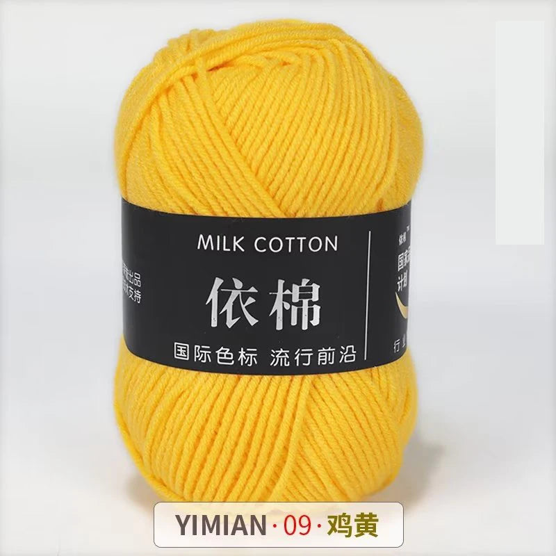 A ball of bright yellow milk cotton yarn labeled YIMIAN 09, ready for knitting or crochet.