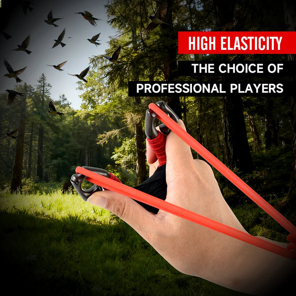 A hand holds a red rubber slingshot, demonstrating high elasticity for professional players in an outdoor setting.