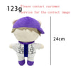 A purple and white collectible plush doll resembling a person wearing a purple hat and a white jacket.