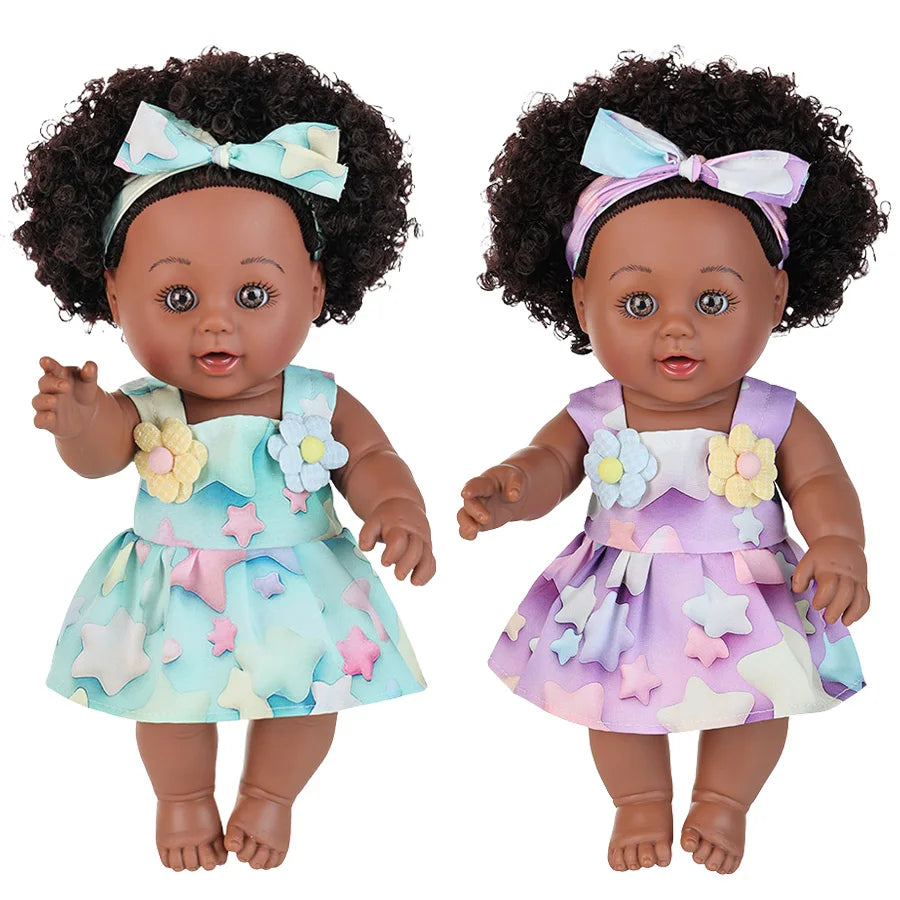 A realistic 12-inch African American baby doll with curly hair wearing a purple and light blue dress and bow