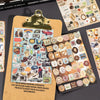 A collection of round stickers and decorative elements on a card with a brass clip.