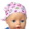 A baby doll wearing a pink patterned hat and outfit set.