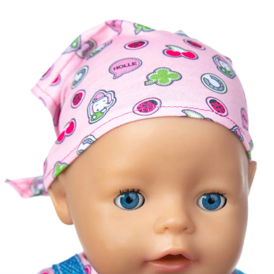 A baby doll wearing a pink patterned hat and outfit set.