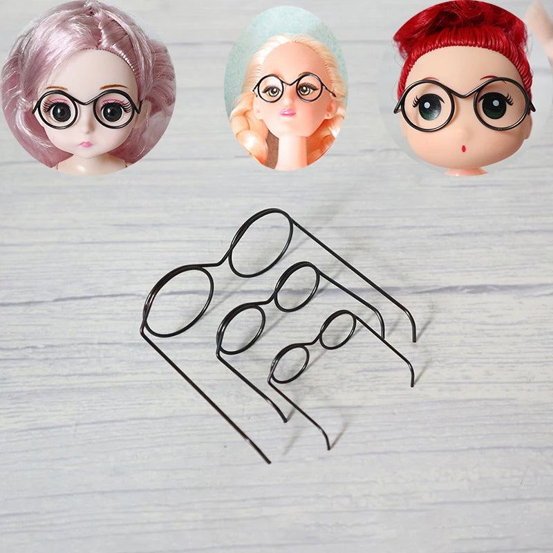 A set of five metal round glasses frames for dolls, featuring various colors and styles.
