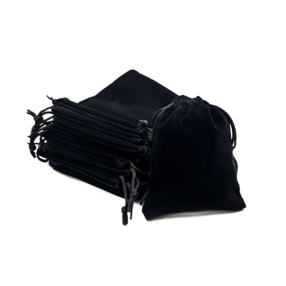 Black velvet drawstring dice bag with gathered fabric and black cord details.