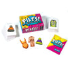 A collection of piles of folding cards and a box labeled Piles! for a party game.