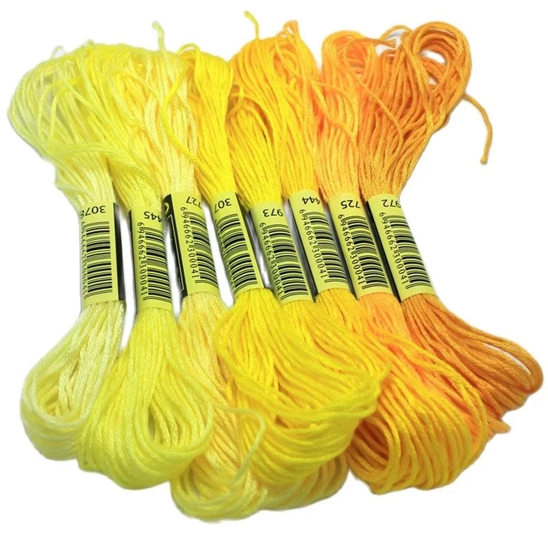 A set of multicolor embroidery floss skeins in yellow and orange colors.