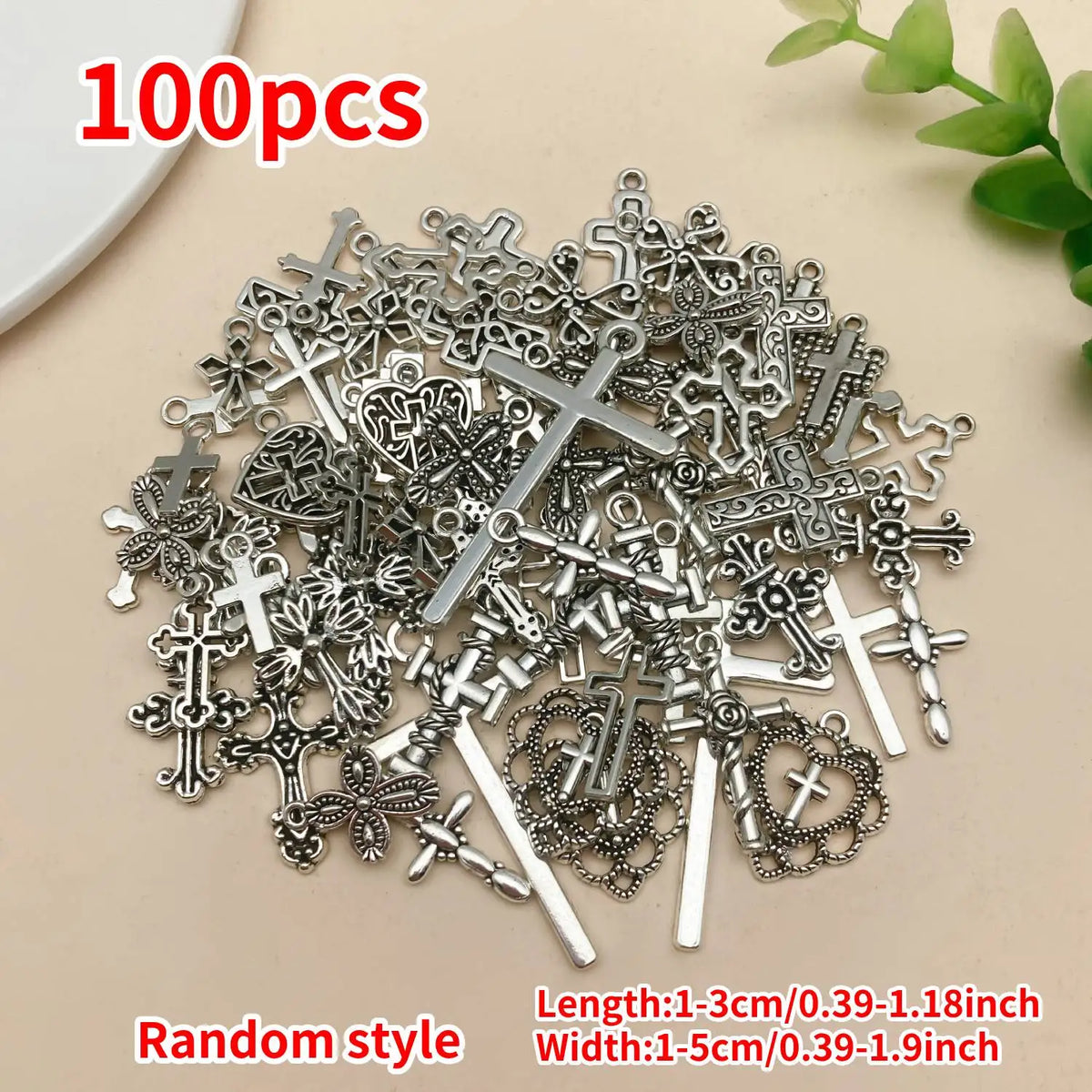 A pile of 100 vintage silver cross charms for jewelry making with random styles.