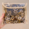 A clear plastic bag filled with a multi-pack of colorful nylon hair ties in various shades of brown, beige, and white.