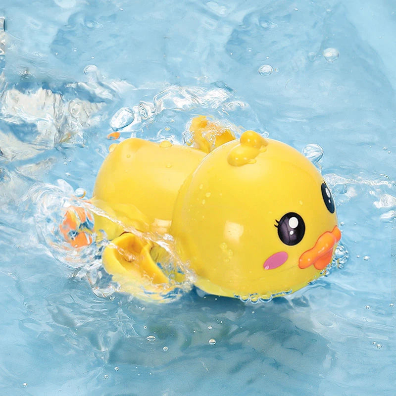 A yellow wind-up frog bath toy floating in clear blue water.
