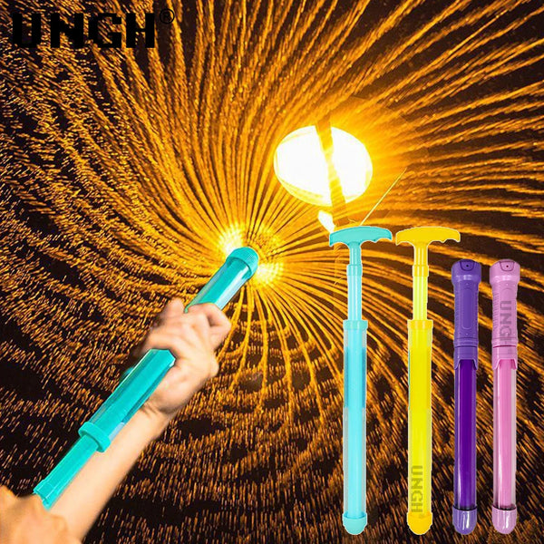 A hand is holding a blue pull-out water gun against a bright, sunburst background with several other colorful guns.