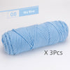 A skein of sky blue soft cotton blend yarn for knitting and crochet, packaged as a 3-pack.