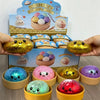 A collection of glitter dumpling squishies in various colors and shapes are displayed on a box.