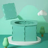 A green foldable baby potty training seat is displayed on a white stand against a light green background.