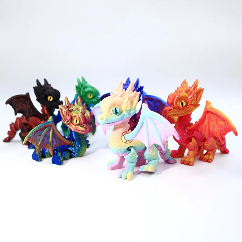 A collection of five articulated 3D printed dragon figurines in various colors including black green orange and purple