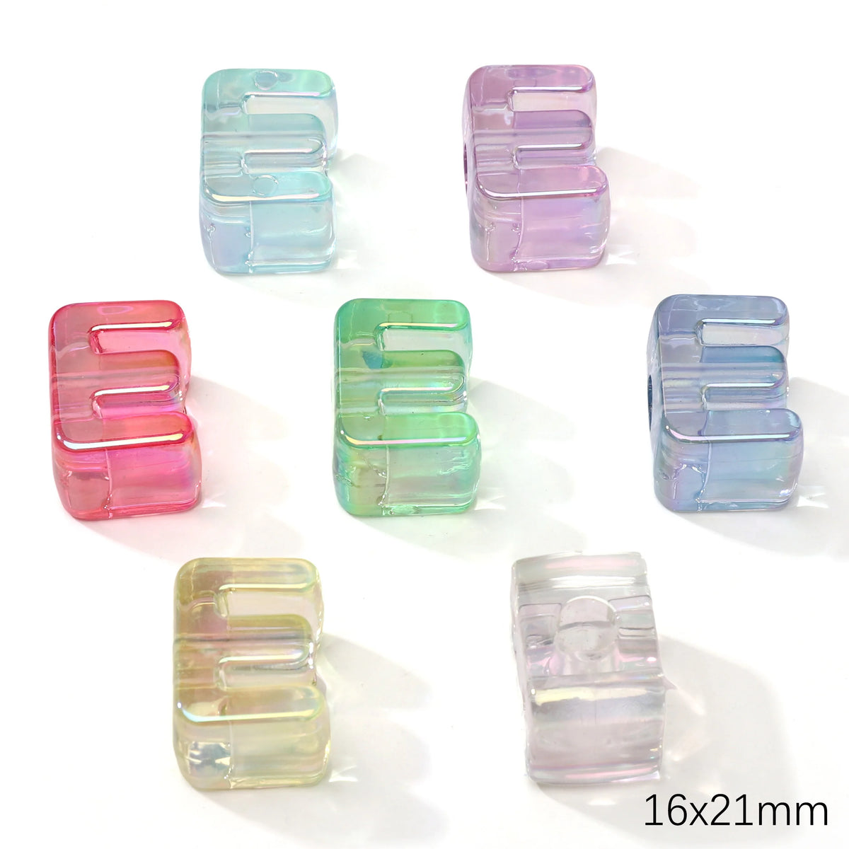 A collection of colorful acrylic alphabet beads in various shades of blue, pink, and green.