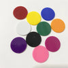 A collection of colorful plastic game markers in various solid colors including red, yellow, blue, green, orange, purple, and
