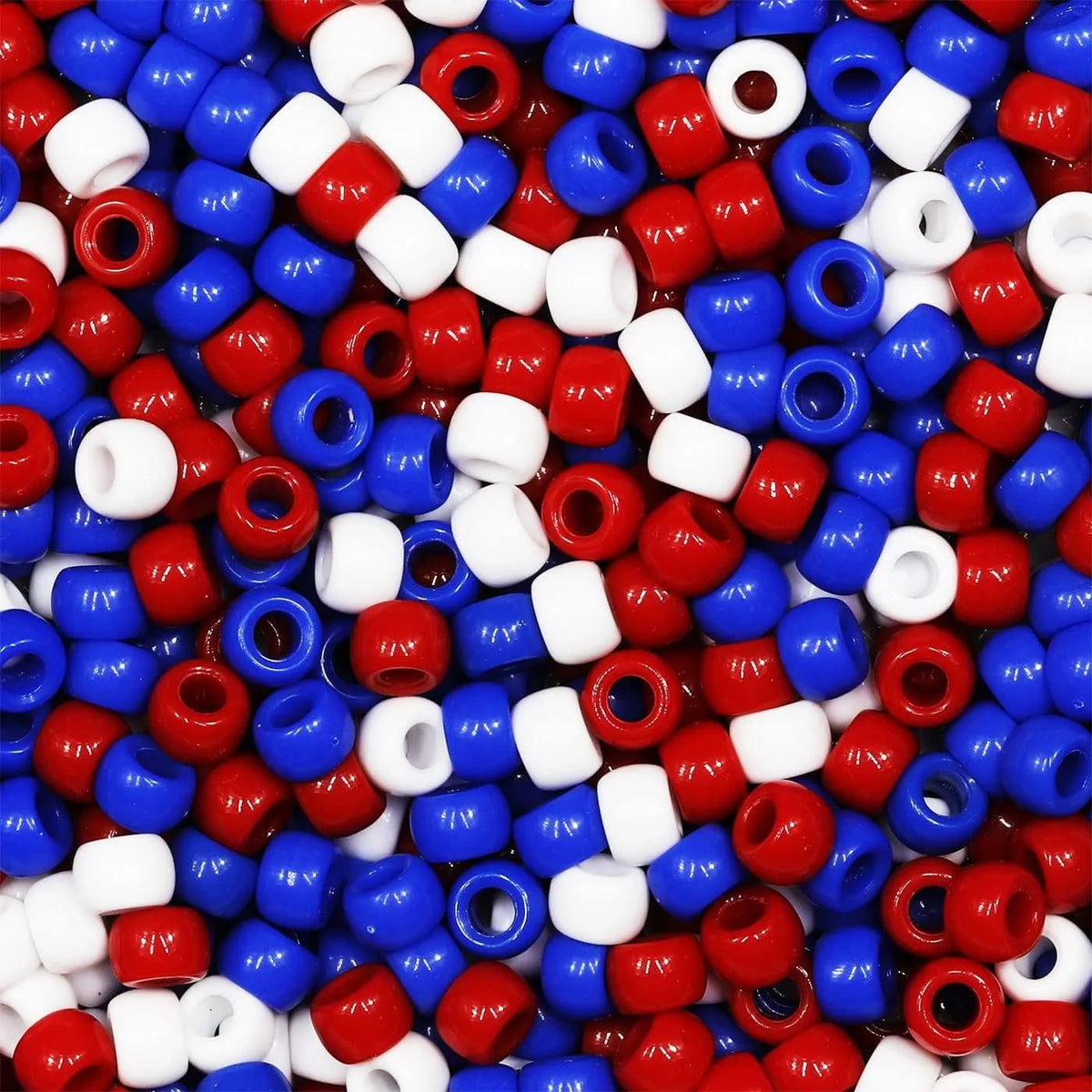 A close-up view of small, colorful pony beads in various shades of red, blue, and white.