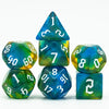A set of seven glitter translucent polyhedral dice, including a pyramid and various numbered dice.