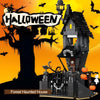 A dark wooden haunted house structure built from building blocks set against a bright orange Halloween background.