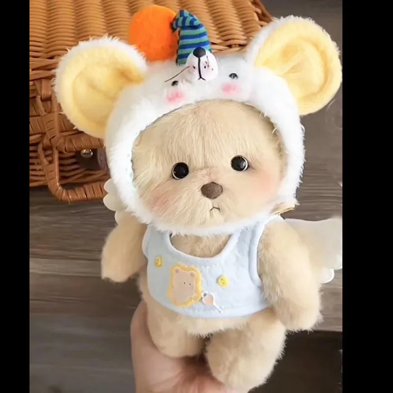 A fluffy white teddy bear plush with large ears and a light blue dress