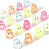 A collection of colorful acrylic ghost beads in pink, yellow, and clear shades arranged on a white surface.