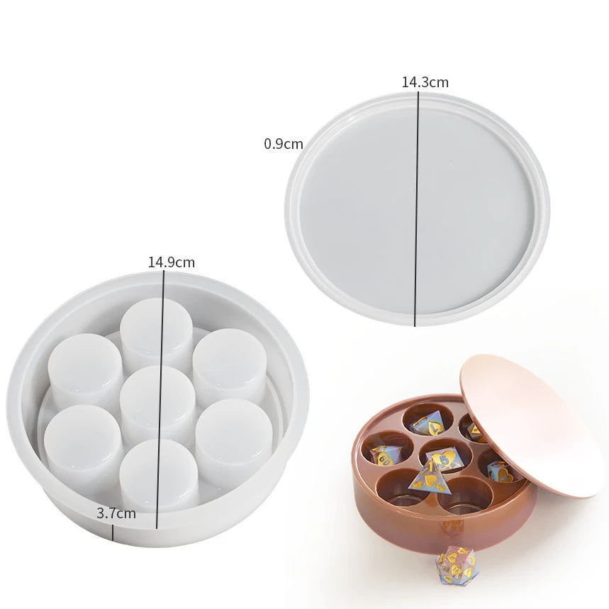 A set of silicone resin molds for custom dice boxes, including a round lid and multiple small dice shapes.