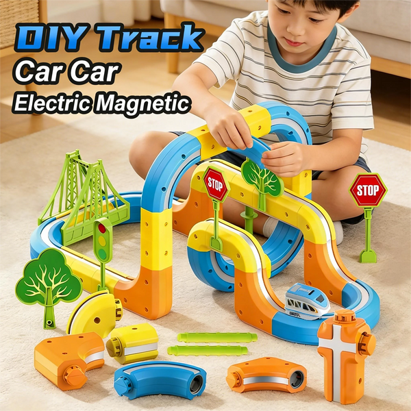 A boy is building a colorful magnetic DIY track car set with various track pieces and an electric engine.