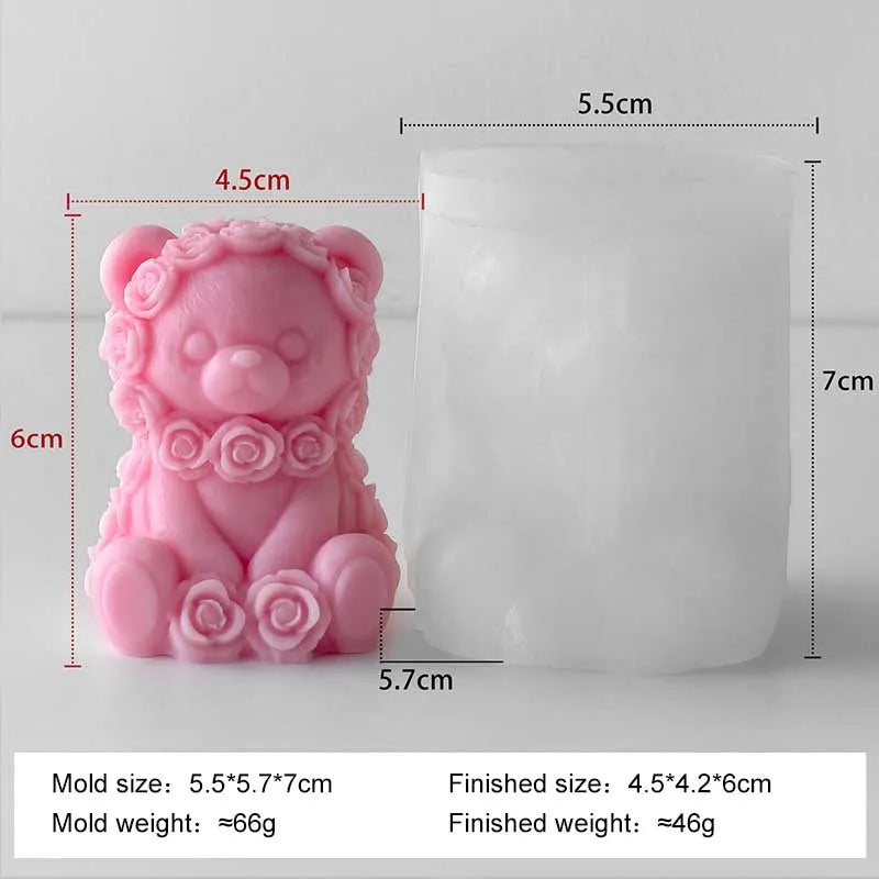 A pink silicone mold shaped like a bear with roses, used for making candles or DIY crafts.