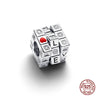 A silver rubik's cube charm with a red heart and letters LVE, set against a white background.