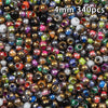 A close-up view of 340 golden gradient glass beads in various colors and finishes.