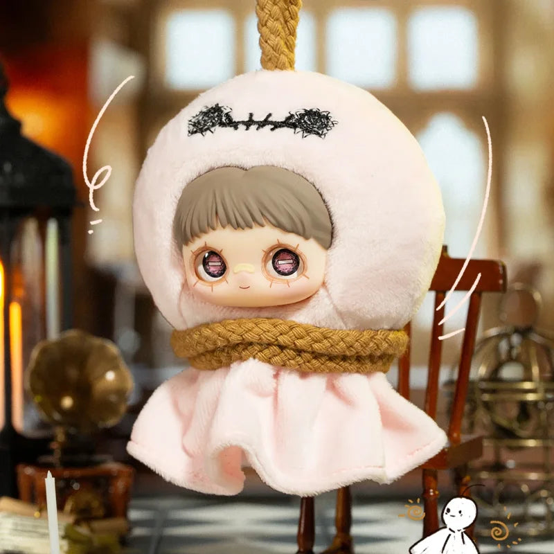 A pink vinyl plush blind box featuring a face with dark hair and purple eyes, bundled in a fluffy hood.
