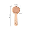 A light wooden bear-shaped musical instrument for toddlers with a rounded head and a long handle.