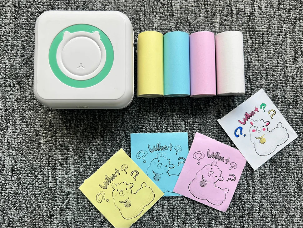 A white pocket thermal printer is shown next to several rolls of colored paper, including yellow, blue, and pink.