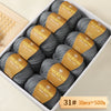 A box of Merino wool yarn in gray and gold labels, showing 10 balls totaling 500g.