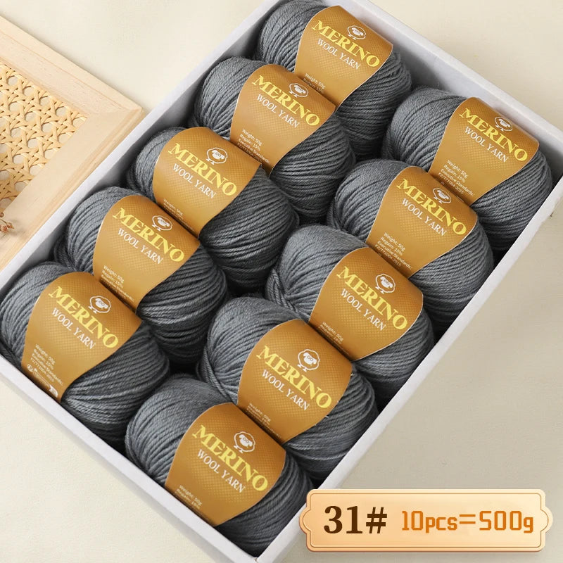 A box of Merino wool yarn in gray and gold labels, showing 10 balls totaling 500g.