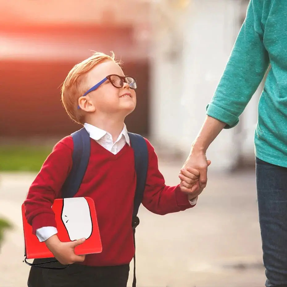 A young boy in a red sweater and white shirt holds a PU leather card binder with a zipper.