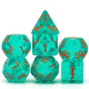 A set of seven translucent teal glitter polyhedral dice, including a tetrahedron and a cube.