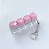 A clear acrylic fidget keychain featuring four pink clicky key buttons attached to a silver keyring.