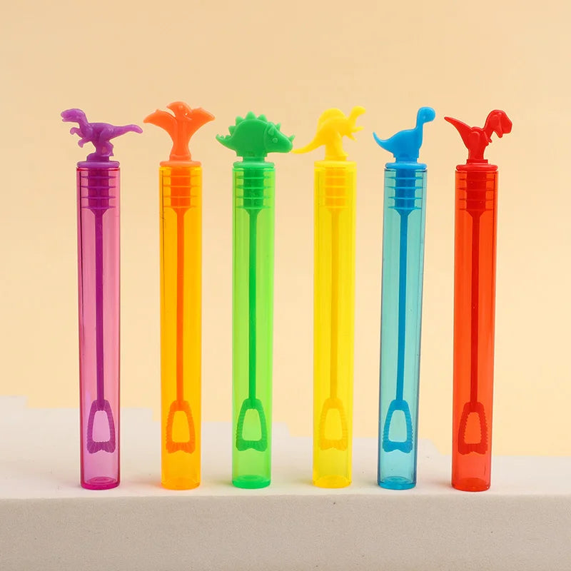 A row of colorful dinosaur-shaped bubble bottles in various shades of pink, orange, green, and blue.