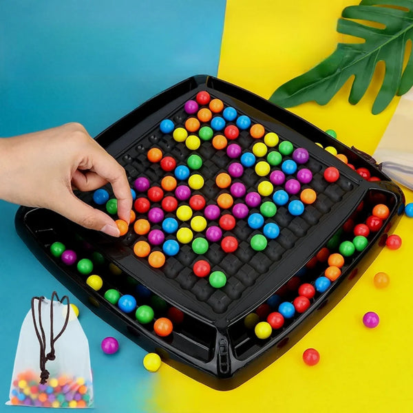 A hand places colorful beads into a black plastic tray for the Rainbow Bead Elimination Game