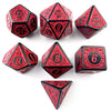 A set of polyhedral dice in red and black, including d10s, d20s, and d6s, displayed on a white background.