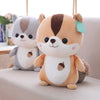 A light brown amigurumi-style fox plush toy with large dark eyes and a green tag.