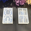 Two clear silicone molds shaped like bears for resin jewelry and crafts are displayed on a dark surface.