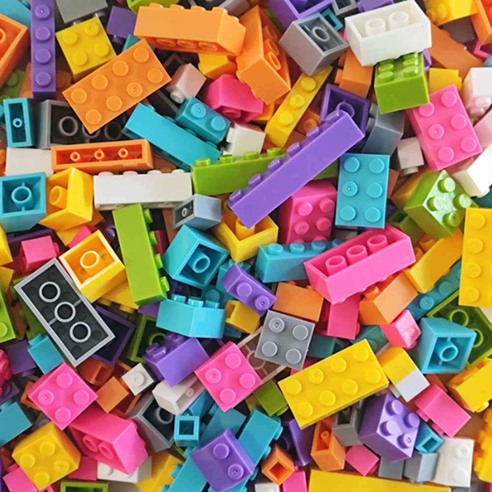 A close-up view of a bulk set of colorful plastic building blocks in various bright colors and shapes.
