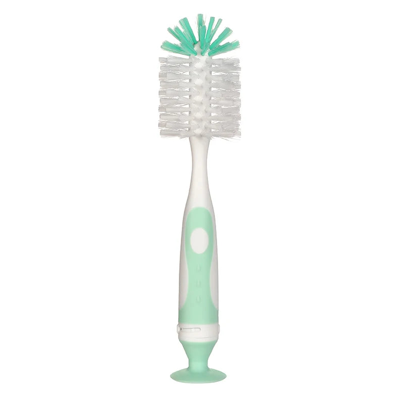 A white baby bottle cleaning brush with a teal bristles and a light green handle and suction stand.
