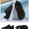 A pair of black minimalist barefoot sneakers shown in various angles, including a full view and a side profile.