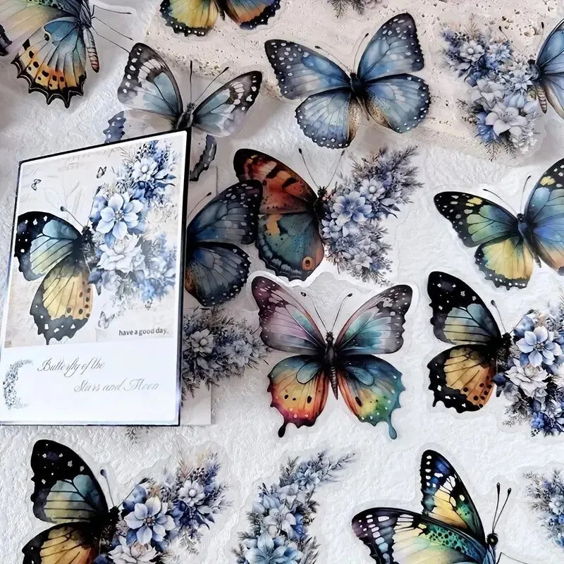 A set of decorative butterfly and flower stickers on white fabric.