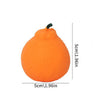 An orange dragon fruit squishy stress relief toy with a green stem.