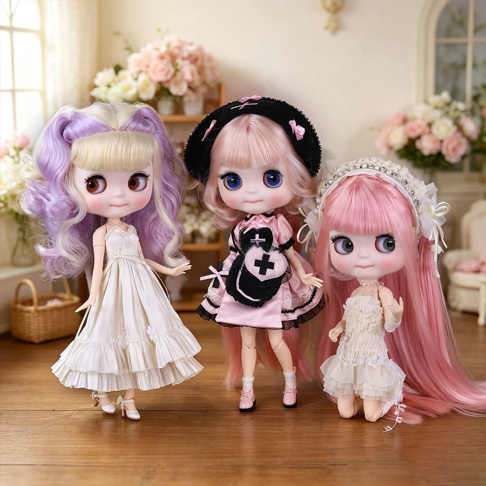 Three Blyth fashion dolls with purple, pink, and pink hair standing on a wooden floor.